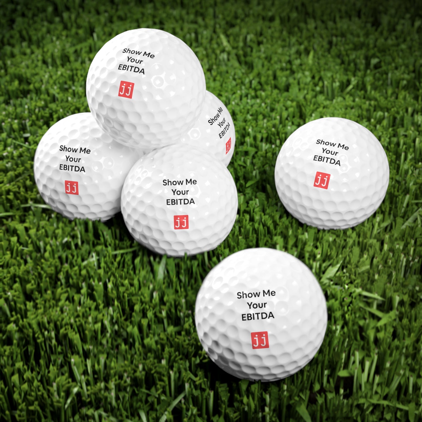Jargon Junkie white golf ball with Show Me Your EBITDA text office golf practice scene with Crush Q4 whiteboard corporate humor SalesLife