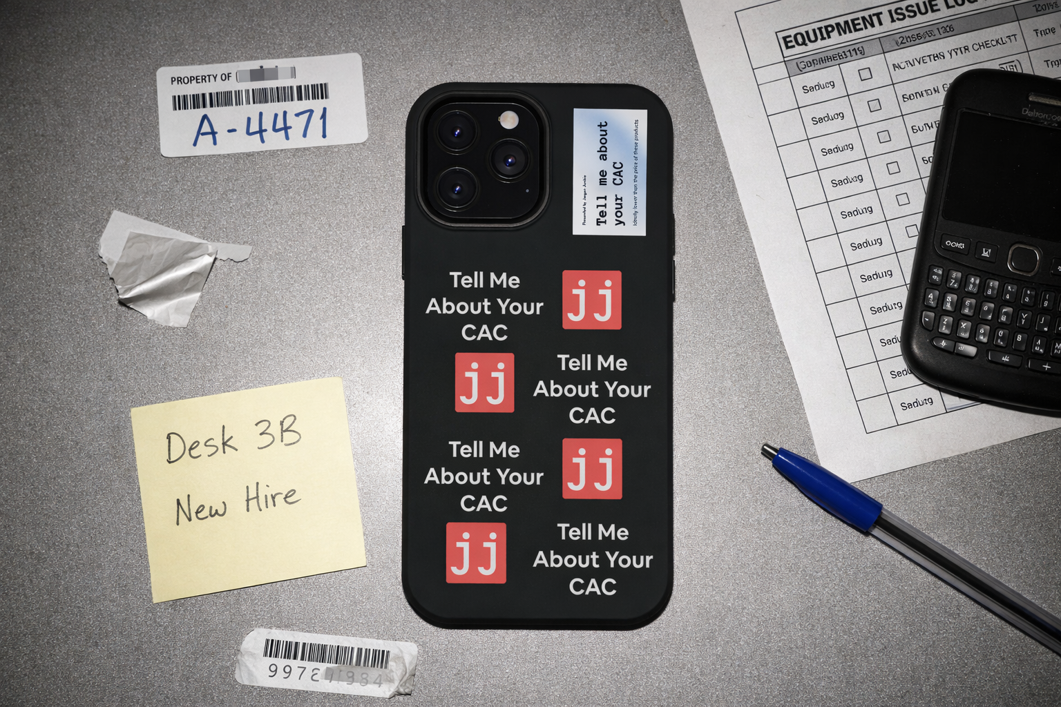 Jargon Junkie black iPhone 13 Pro Max case with Tell Me About Your CAC text and JJ logos on office desk with equipment issue log corporate humor phone accessory