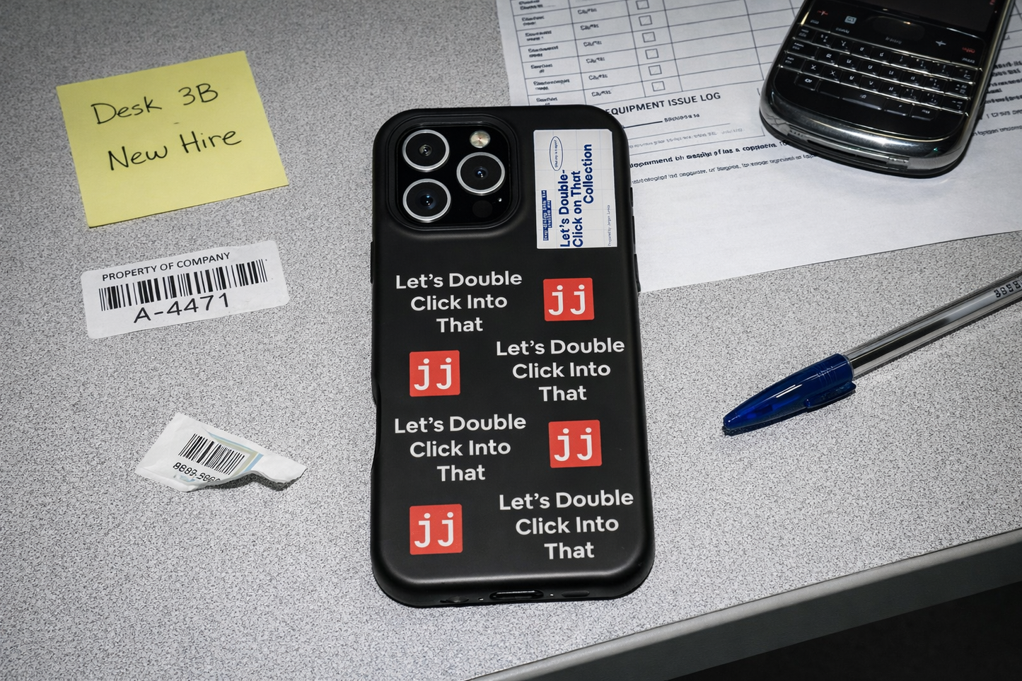 Jargon Junkie black iPhone 16 Pro Max case with Let's Double Click Into That text and JJ logos on office desk with equipment issue log corporate humor phone accessory